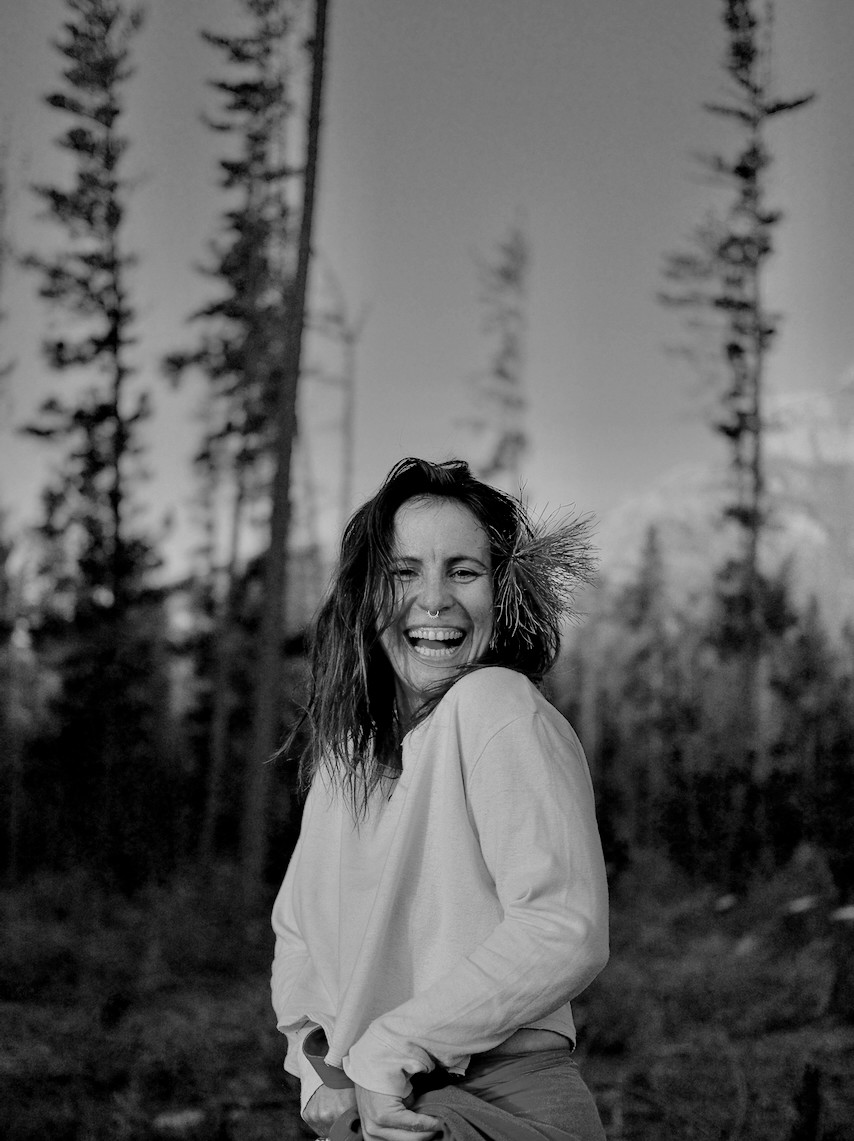 Nallaee Seetal laughing outdoors among trees